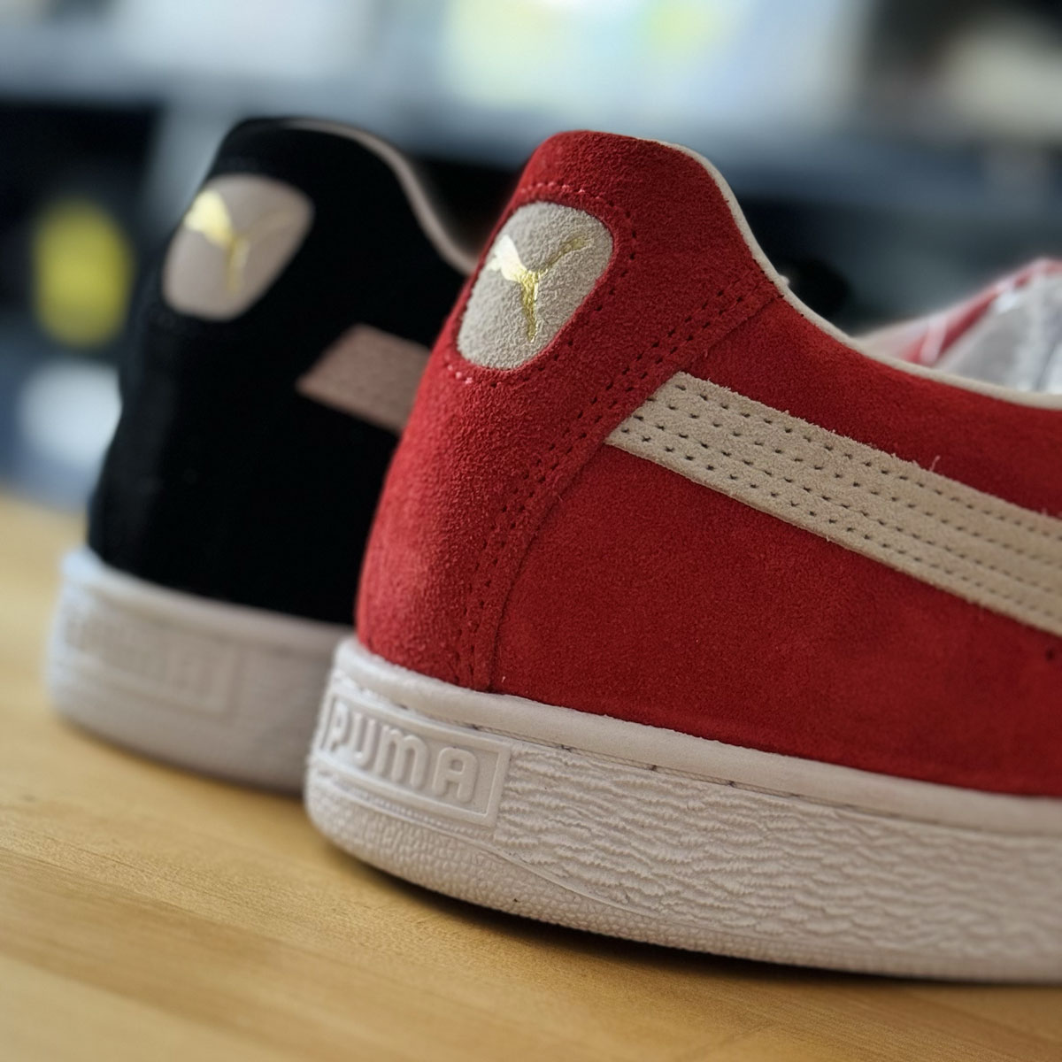 Close-up of the formstripe on a red and black PUMA Suede