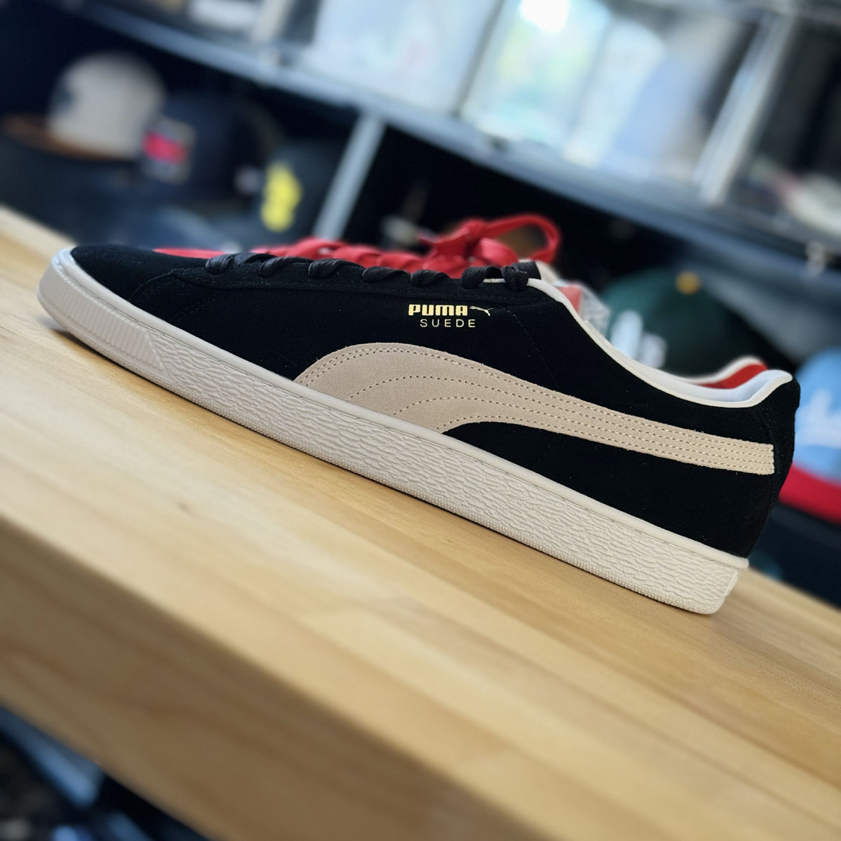 Side profile of a red and black PUMA Suede sneaker